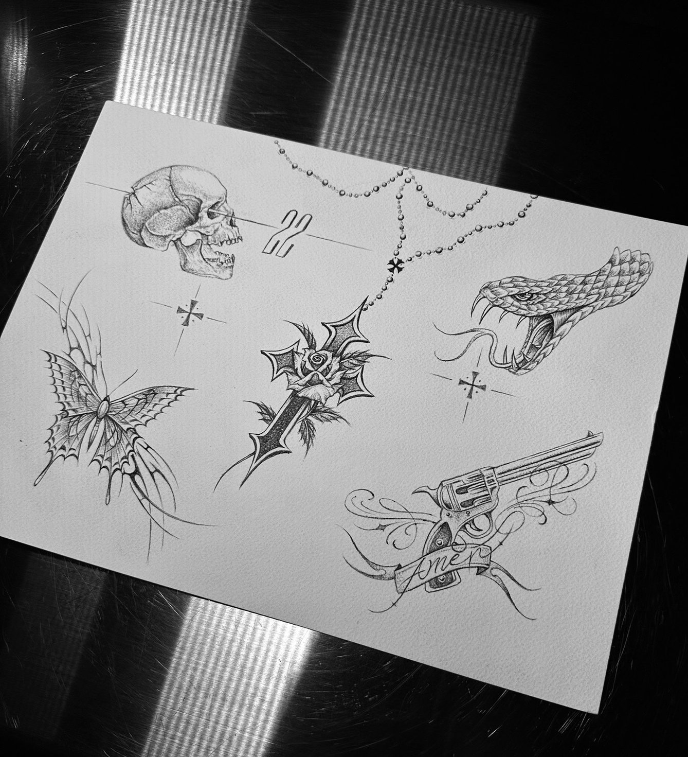 tattoo flash sheet: skull, rosary, revolver