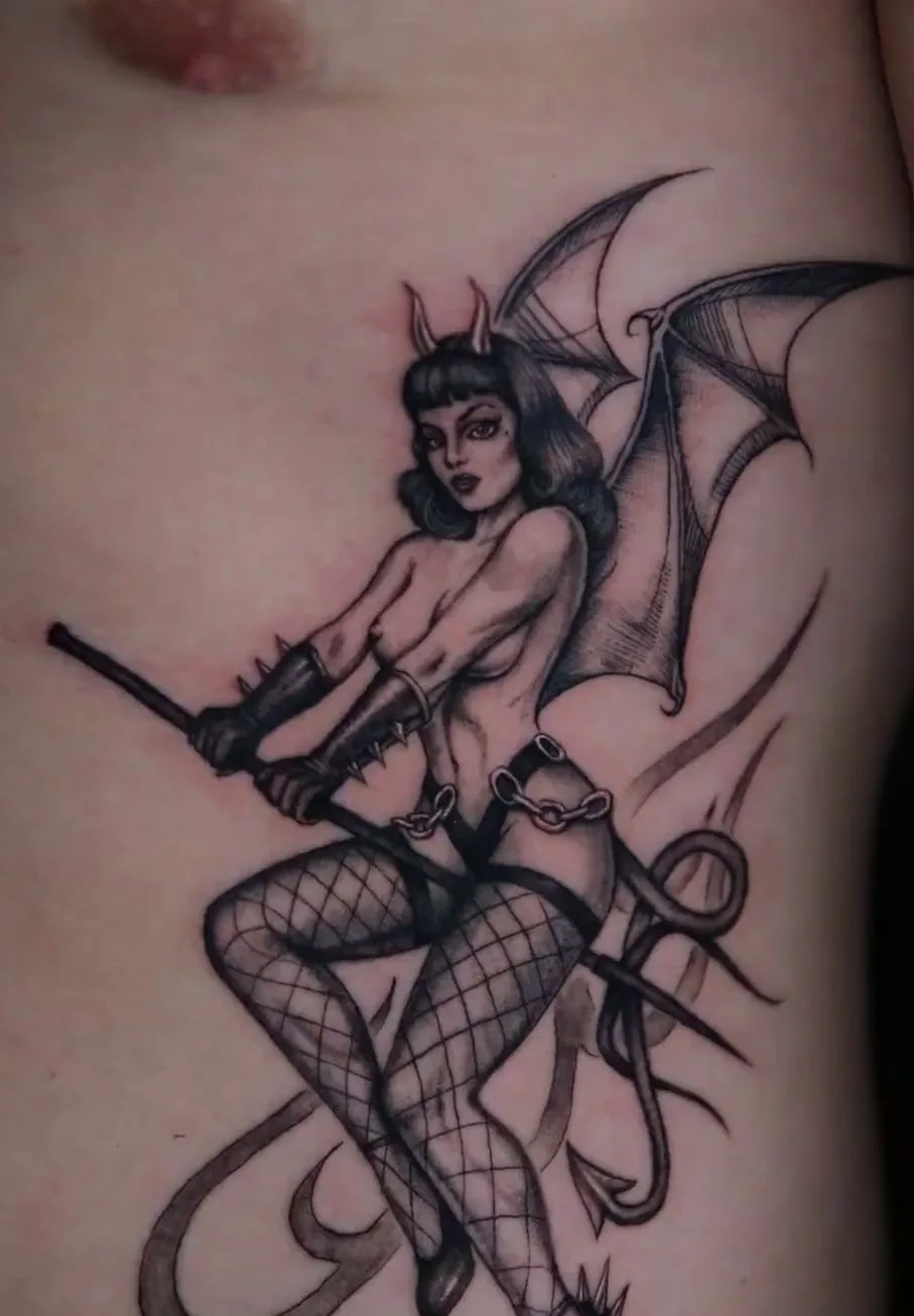 fine line tattoo, winged pin-up on the ribs