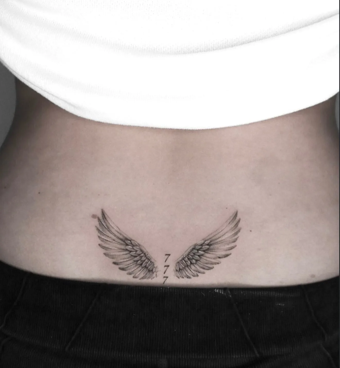 fine line tattoo, wings on the lower back
