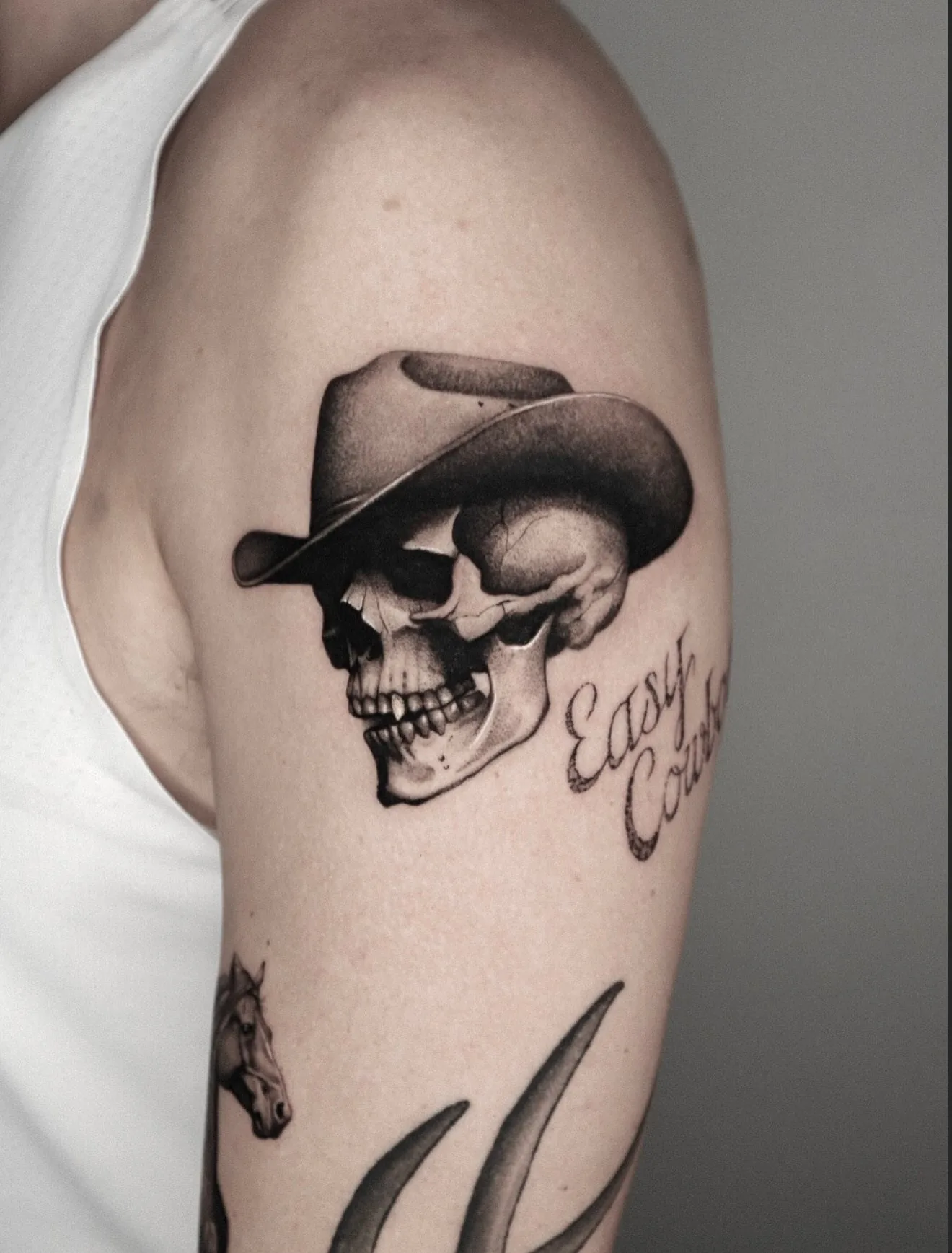 realism tattoo, cowboy skull on the shoulder