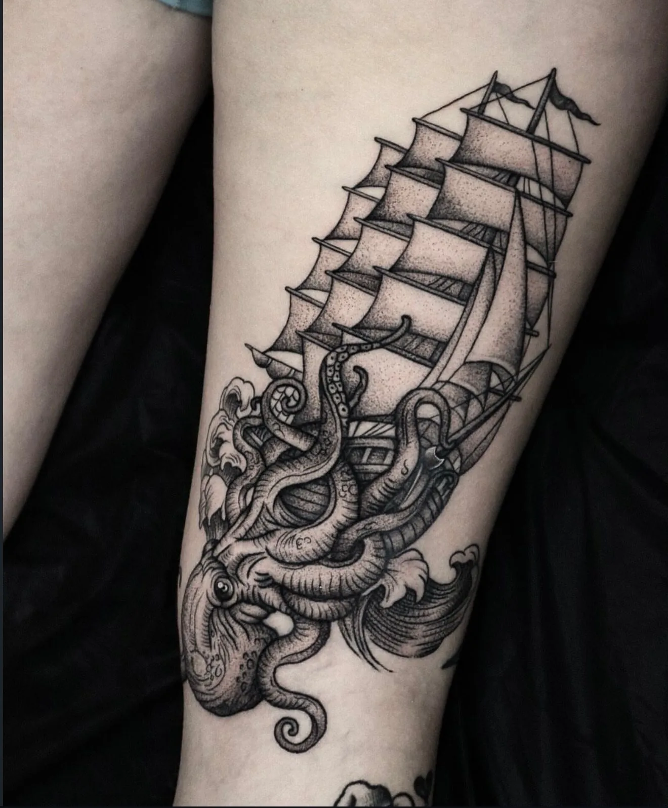 blackwork tattoo, ship and kraken on the leg