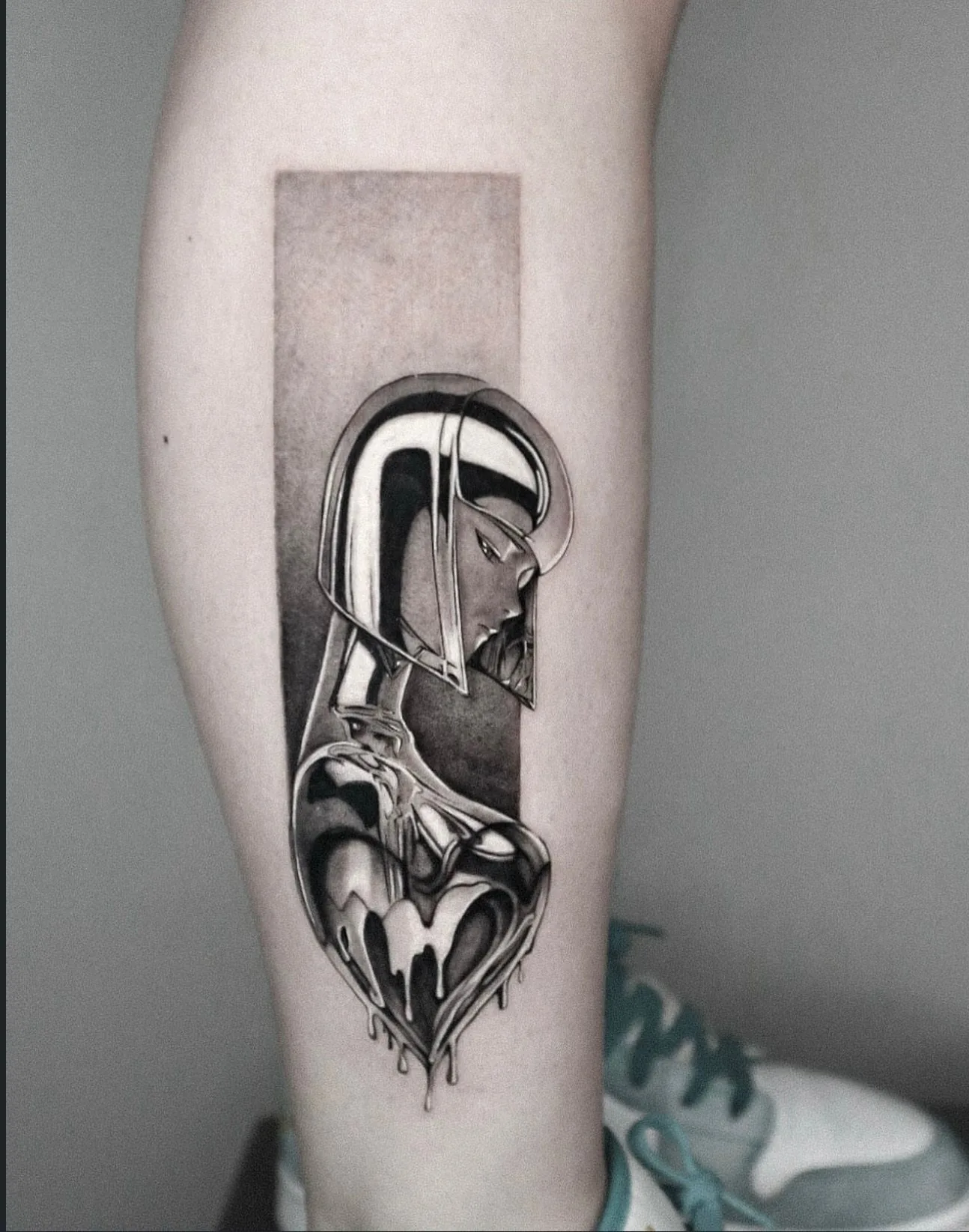 modern tattoo, chrome heart on the calf