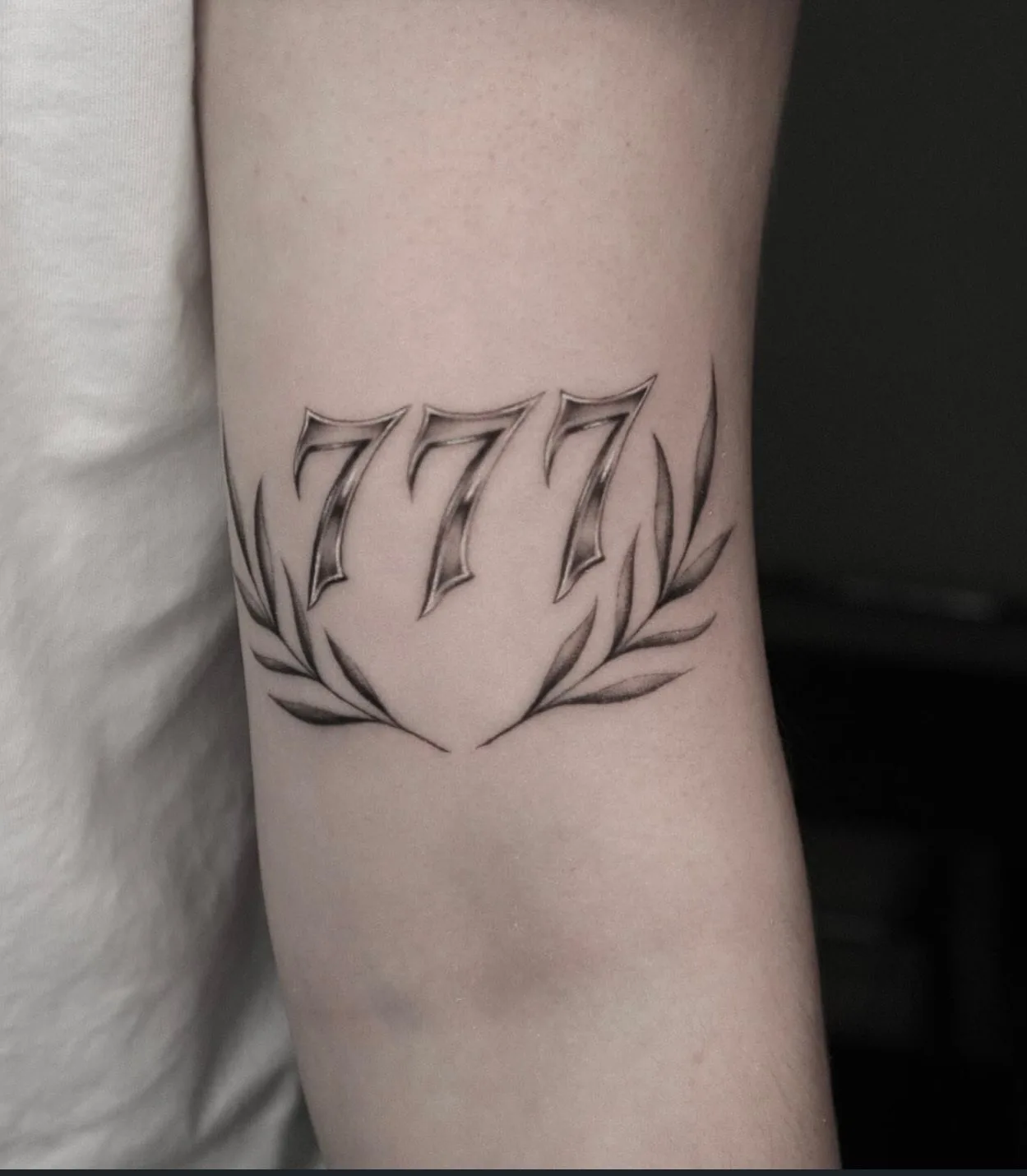 fine line tattoo, 777 on the arm