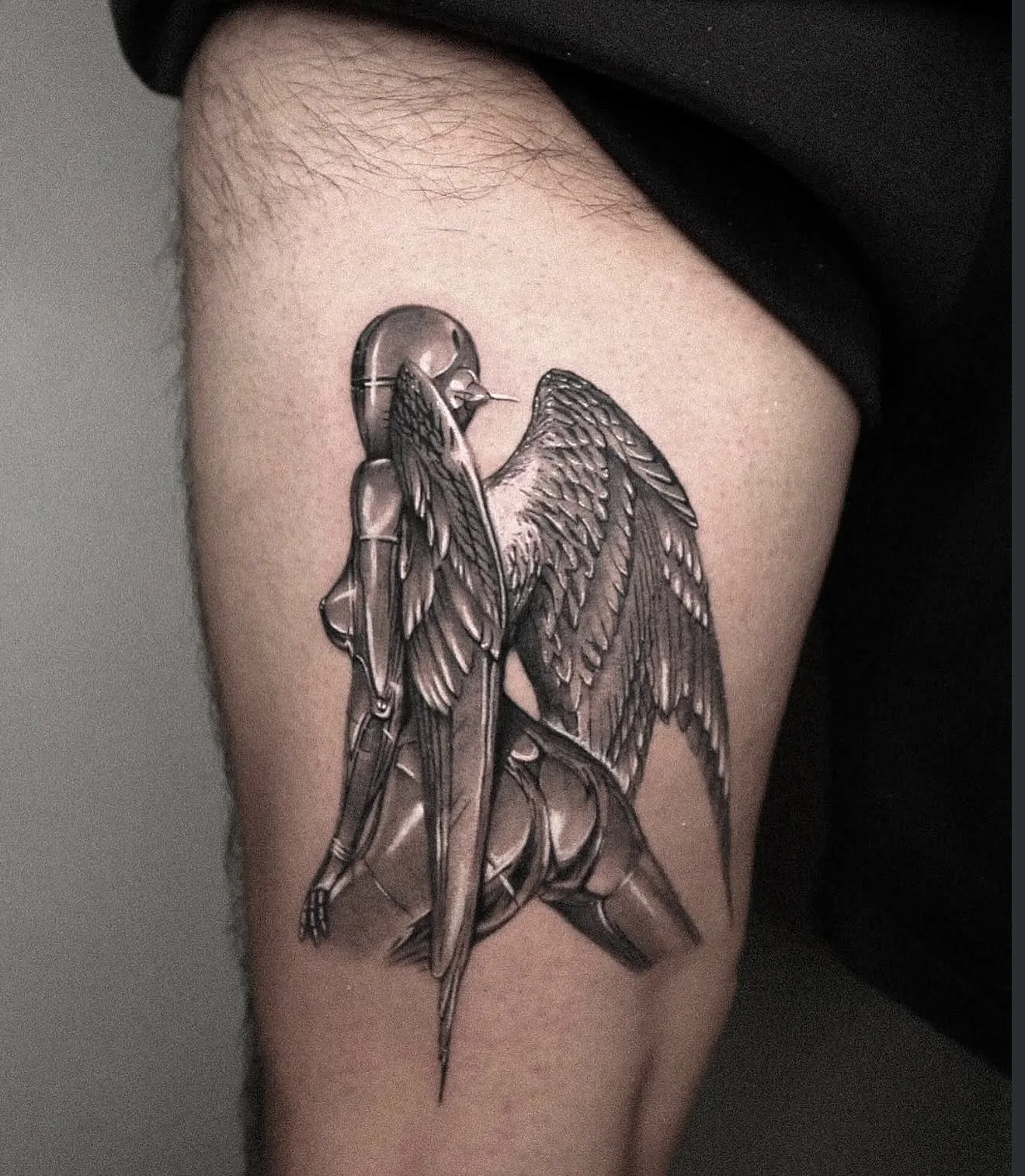 realism tattoo, winged figure on the thigh