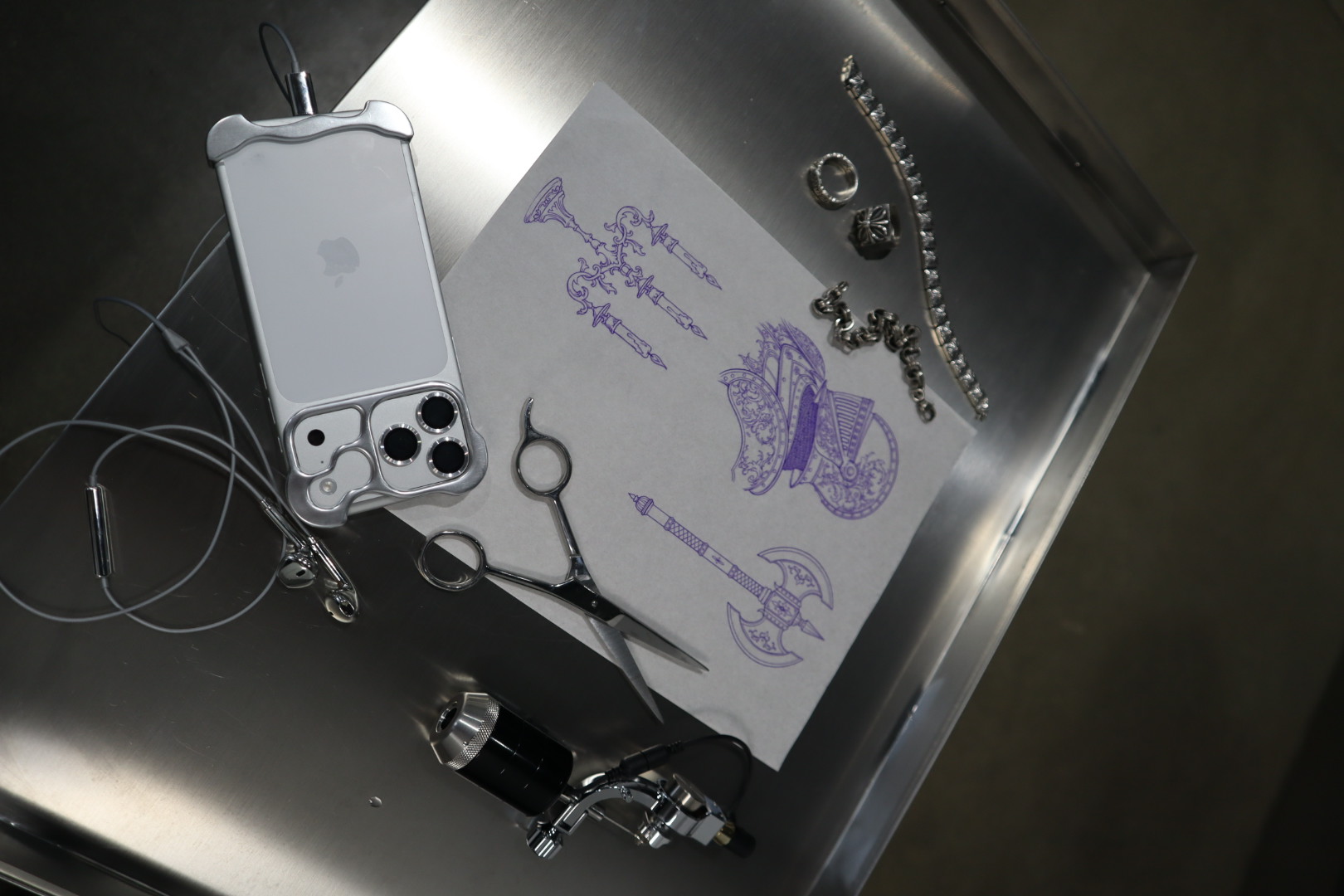 tattoo stencil and machine on a steel tray